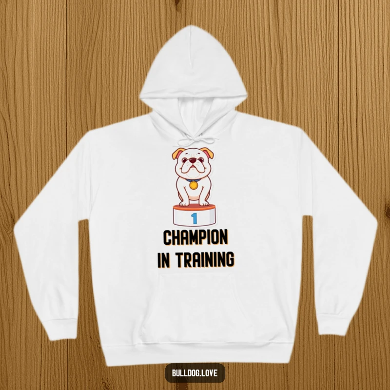 Funny hoodie featuring a proud bulldog wearing a medal, standing on a podium, embodying triumph and comfort in a humorous design.