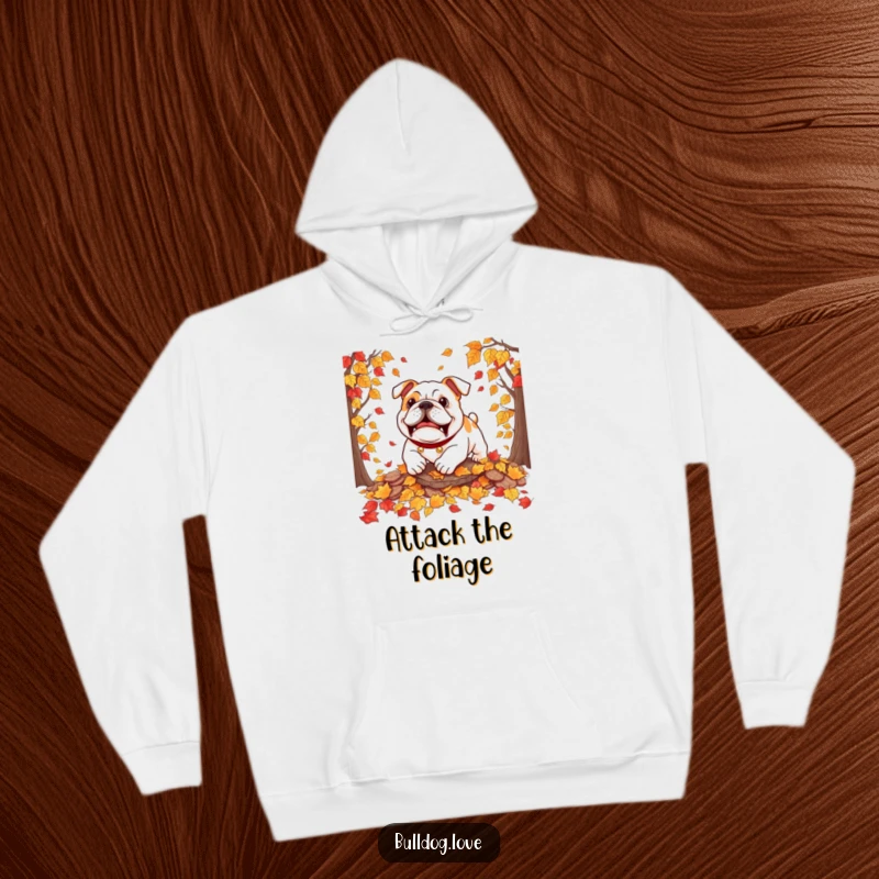 Funny bulldog hoodie featuring a dog playfully pouncing on autumn leaves, capturing the joy of the season.
