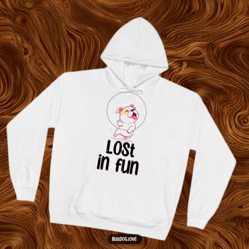 Funny hoodie showing a bulldog joyfully and playfully chasing a huge, iridescent bubble with immense enthusiasm.