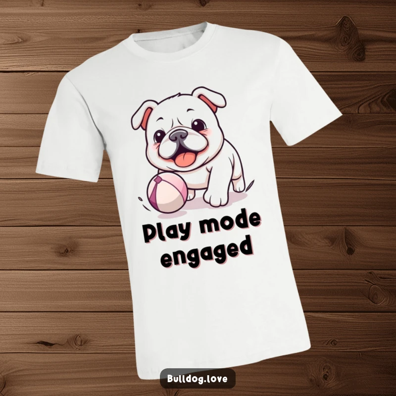 Funny Kawaii Bulldog T-Shirt showing a dog enthusiastically chasing a bouncing ball, perfect for expressing a love for play and fun.